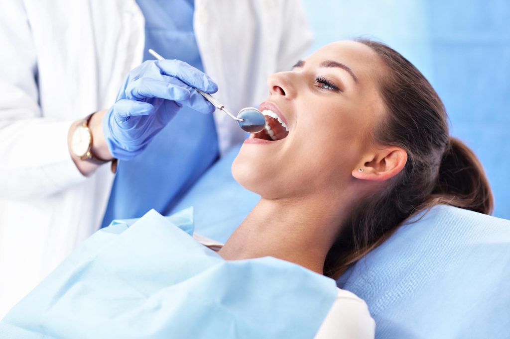 dentist examining patient after root canal in Greenville SC